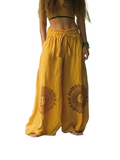 Yellow vintage casual wide leg pants with earthy brown circular embroidery on the lower legs in casual pants style