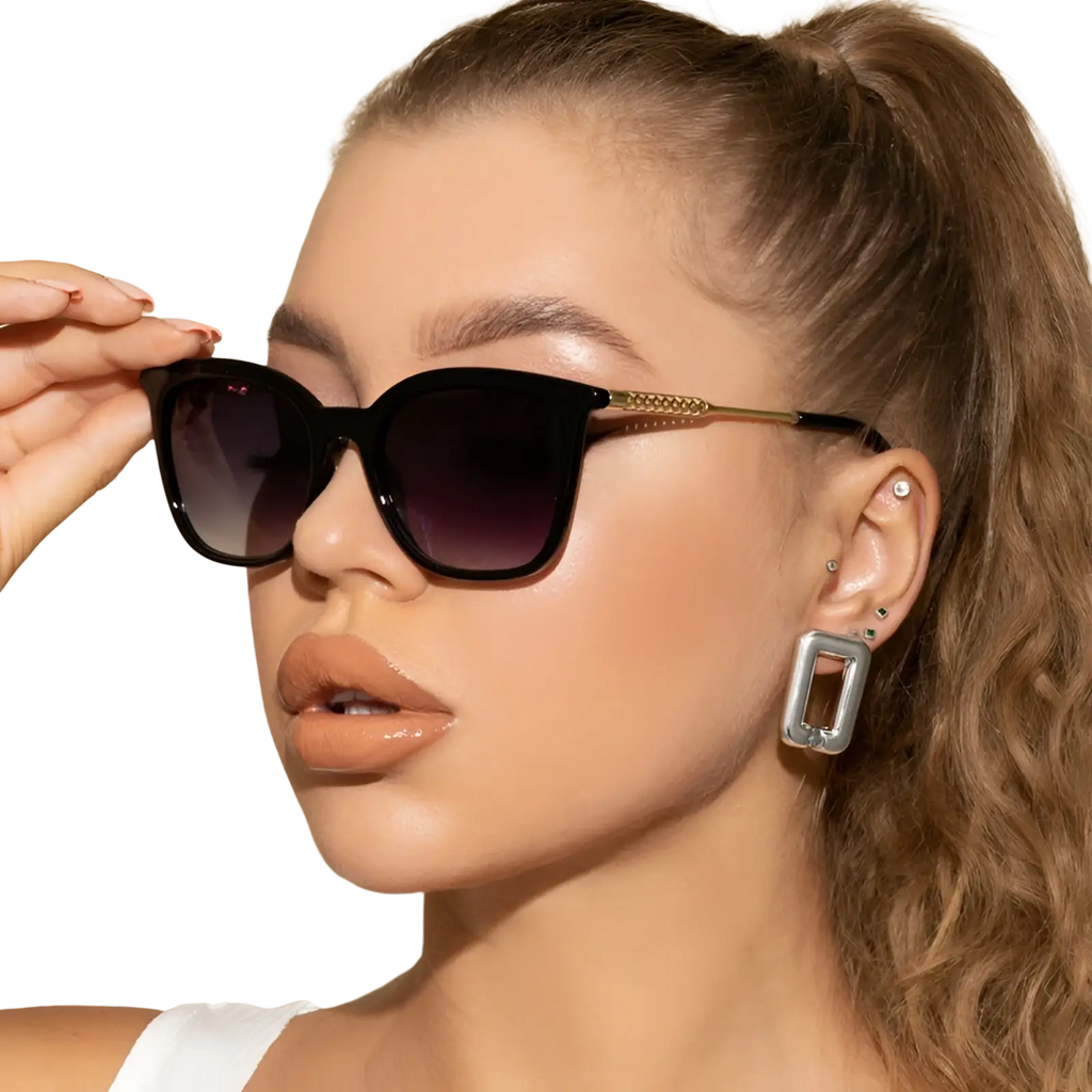 Vintage cat eye sunglasses with black frames, gradient dark lenses, and gold-tone beaded temple arms
