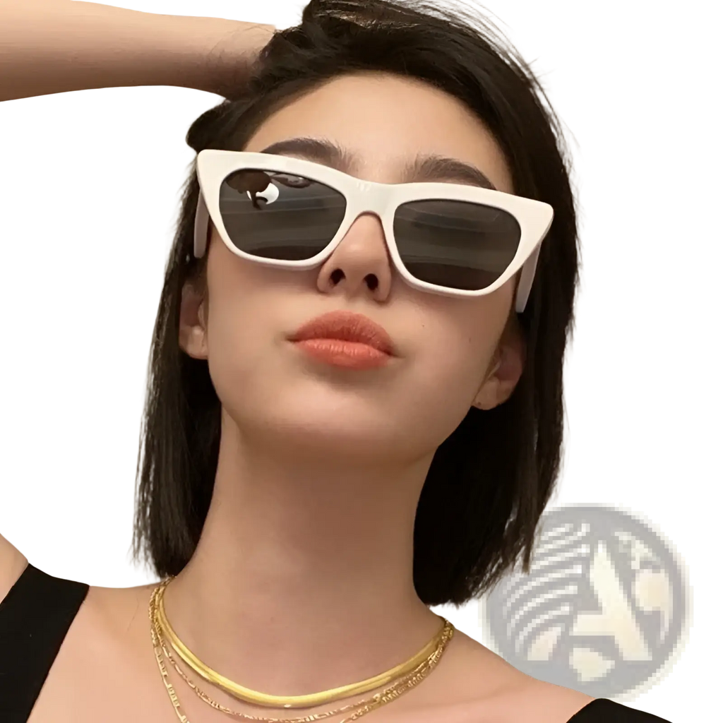 White cat-eye sunglasses with dark lenses featuring vintage tortoiseshell and acetate frame materials