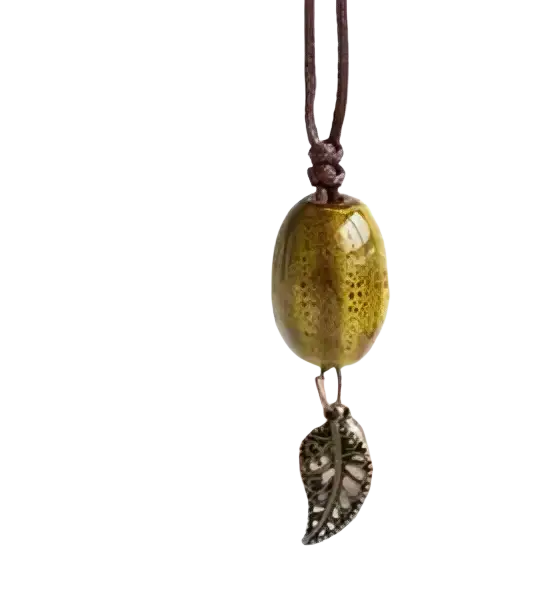 Vintage ceramic leaf pendant necklace for women featuring a golden oval bead and a silver leaf charm on brown cord
