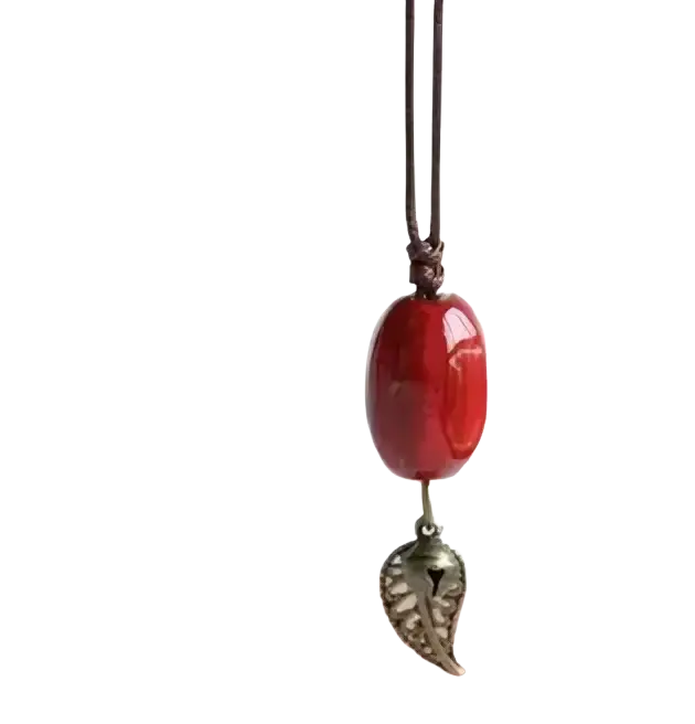Vintage ceramic leaf pendant necklace for women featuring a red oval bead and silver charm on dark brown cord