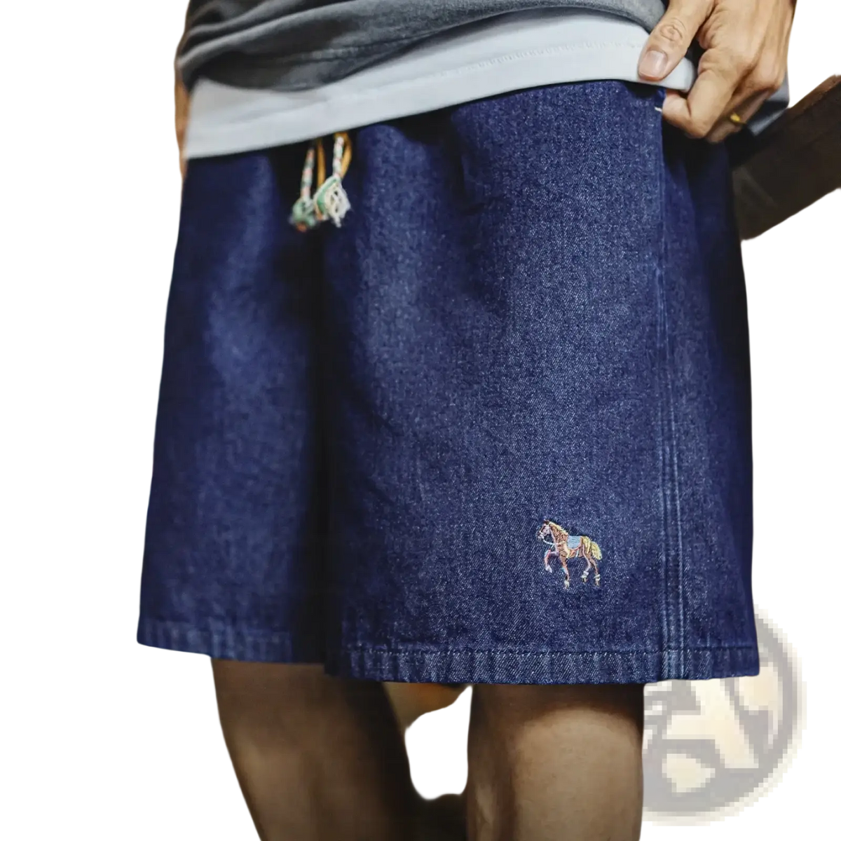 Dark blue denim shorts for men featuring a small embroidered horse on the lower leg made of vintage denim