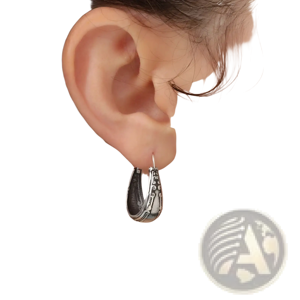 Vintage engraved silver alloy hoop earring with intricate textured detailing and a slightly curved design
