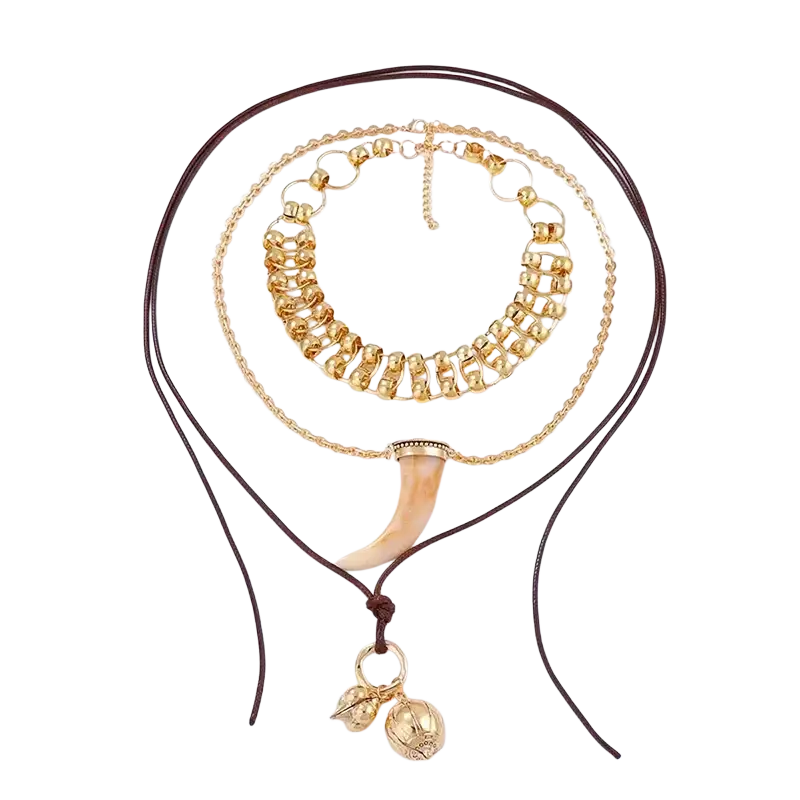 Vintage ethnic layered pendant necklace for women in gold tone featuring tusk pendant and decorative beads on braided cord