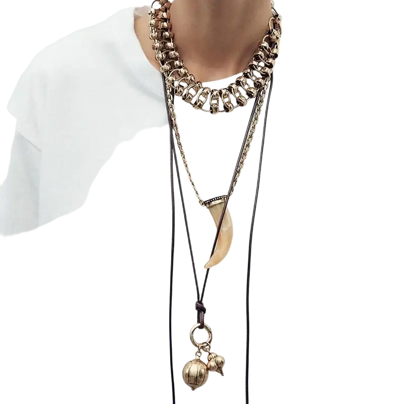 Vintage ethnic layered pendant necklace for women featuring gold-toned chains with tooth-shaped pendant and bell charms