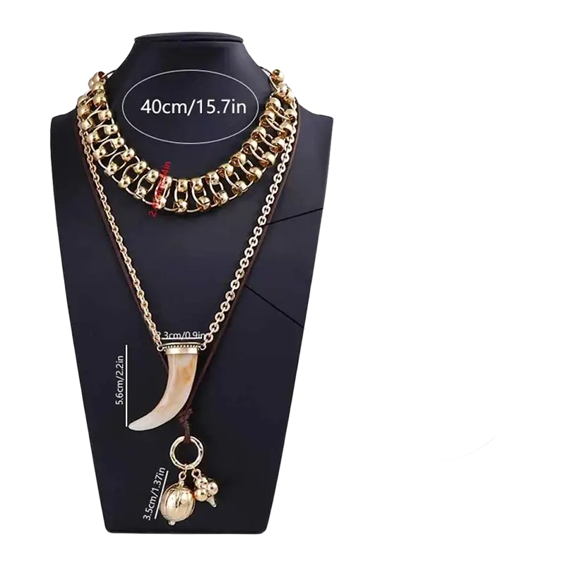 Vintage ethnic layered pendant necklace for women in gold tone with ivory tusk pendant and smaller gold charms on bust