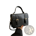 Black leather vintage satchel with gold-tone buckles and a top handle made of faux leather