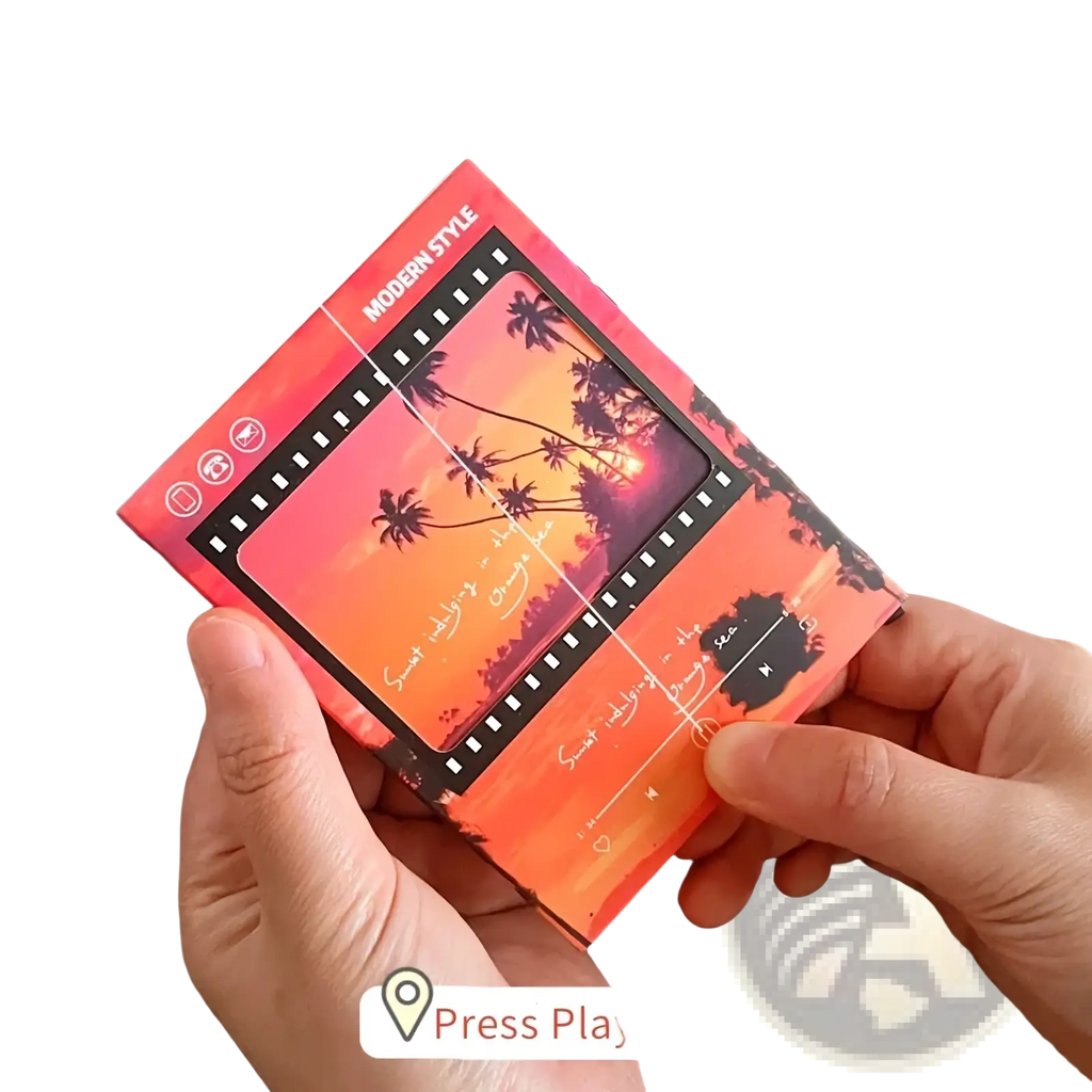 Vintage filmstrip cassette music greeting card featuring a vibrant orange and pink notebook with tropical sunset design