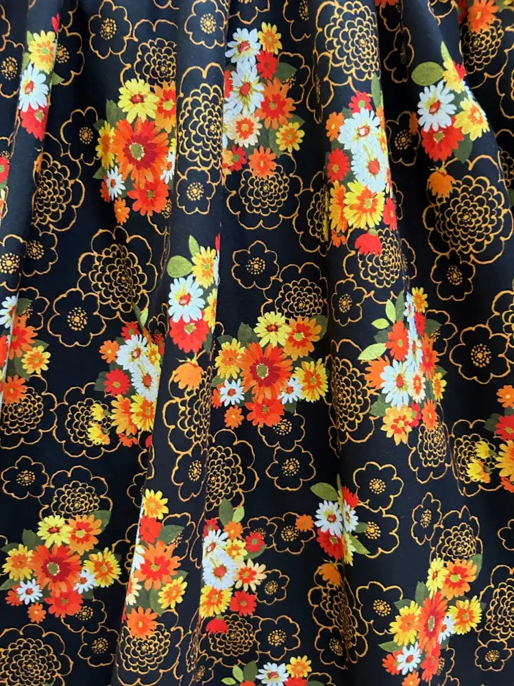 Vintage floral greta cotton v neck knee length dress with vibrant orange yellow and white blossoms on navy fabric