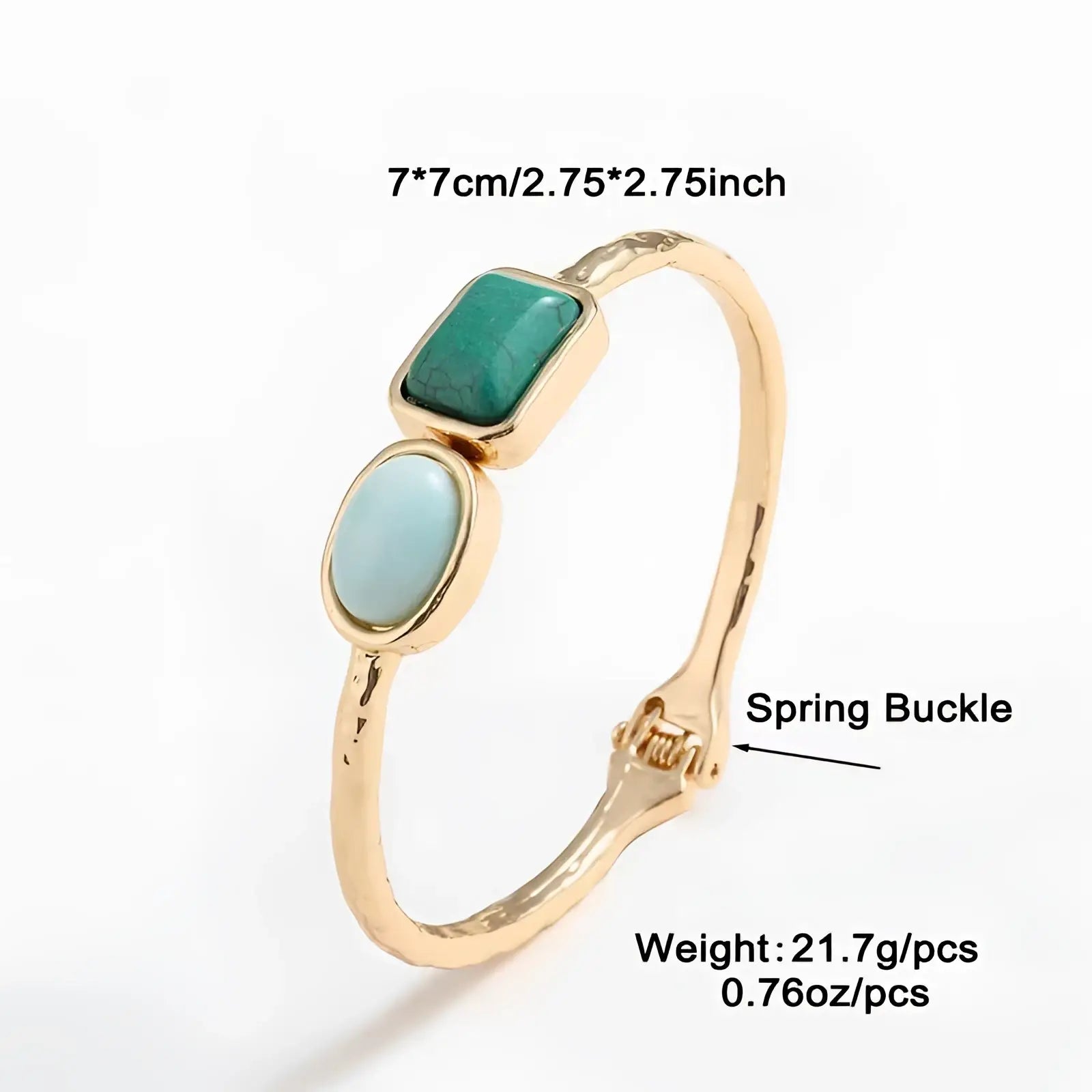 Vintage hammered gold bangle featuring two turquoise stones one rectangular and one oval in gold tone