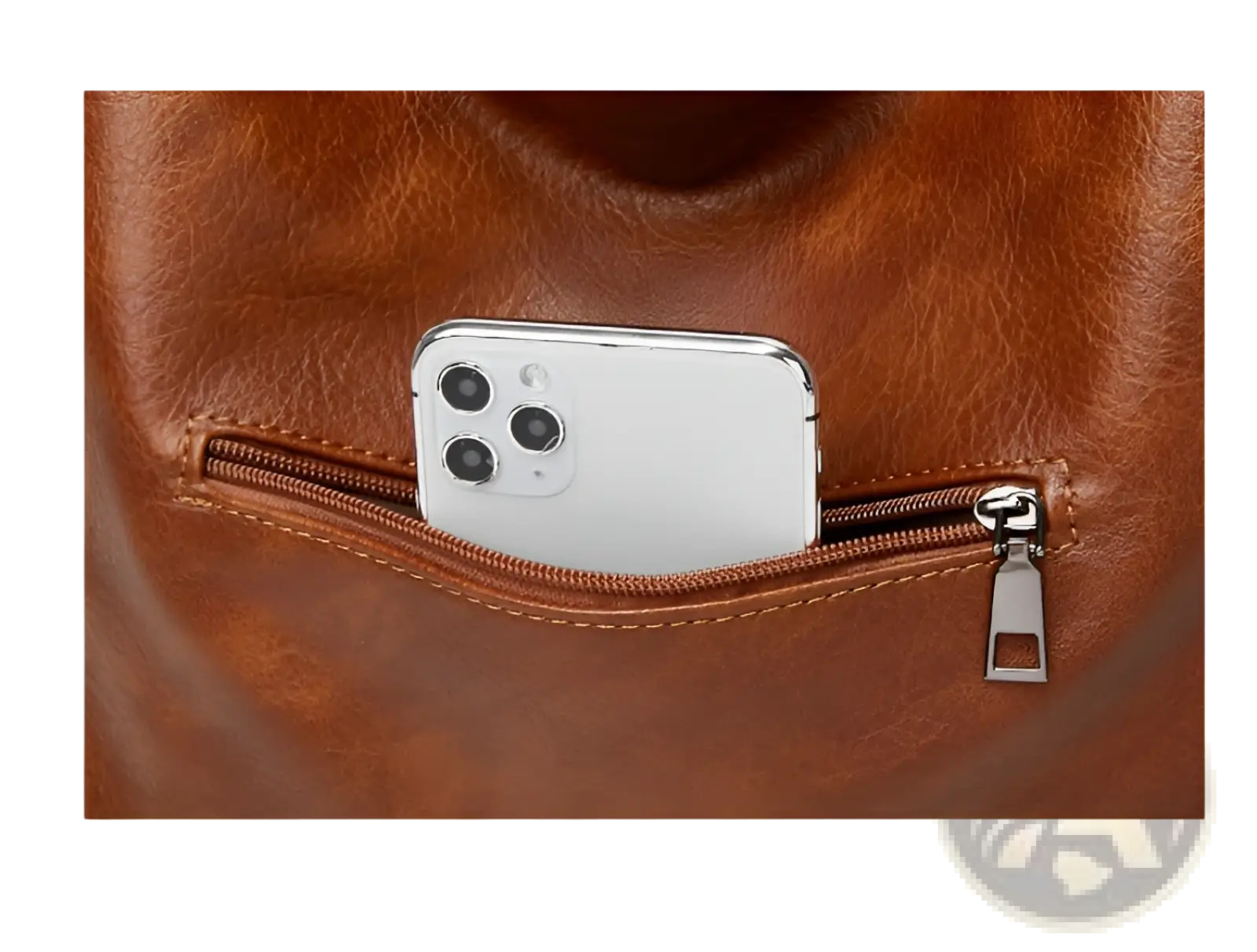 Brown leather vintage tote bag multi pocket shoulder purse shown from back with zip pocket holding white smartphone
