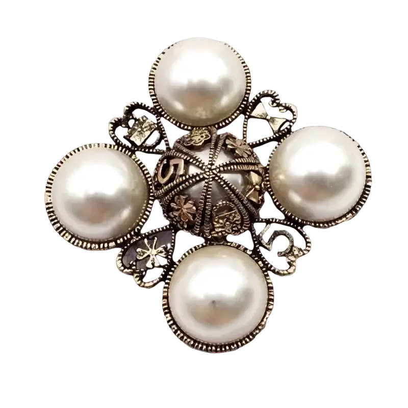Vintage pearl designer brooch pin in silver tone with four white pearls and ornate filigree heart-shaped accents