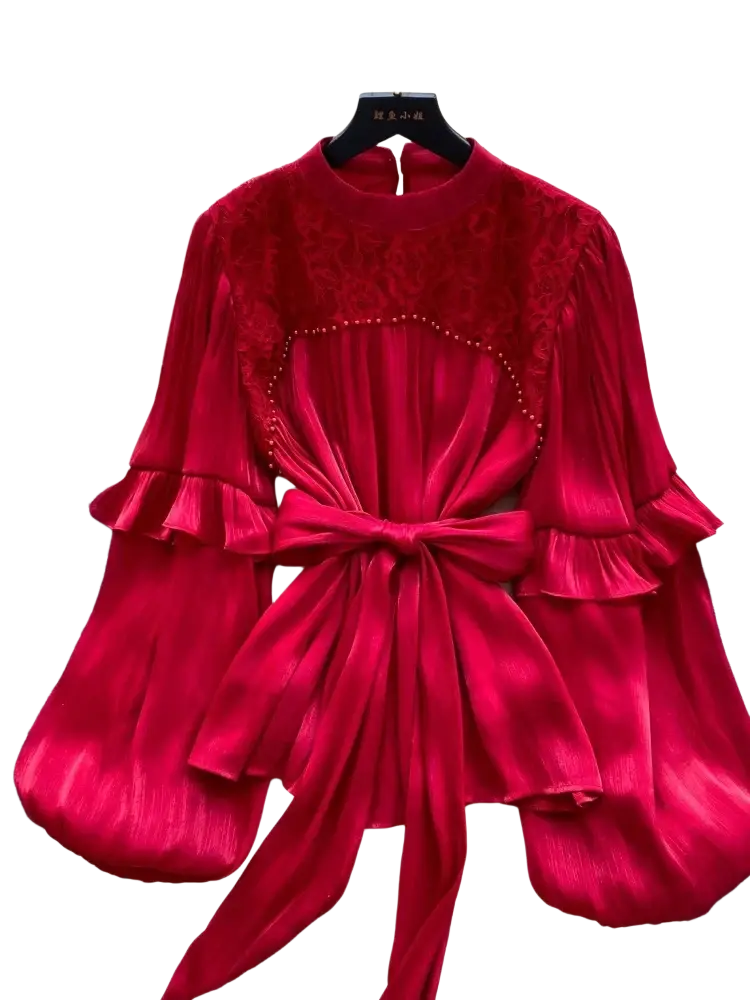 A rich red velvet vintage puff sleeve blouse with lace detailing and a matching bow at the waist for y2k streetwear