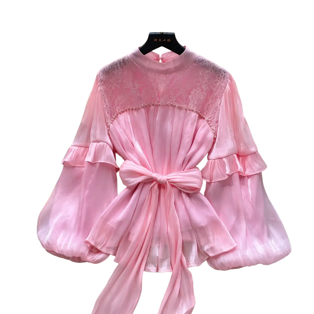 A soft pink sheer chiffon vintage puff sleeve blouse with lace neckline and ruffled sleeves tied at the waist