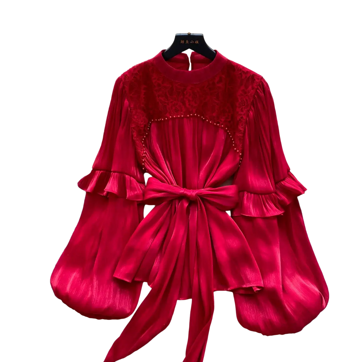 A vibrant red vintage puff sleeve blouse with velvet bodice lace detailing and flowing satin skirt tied at the waist