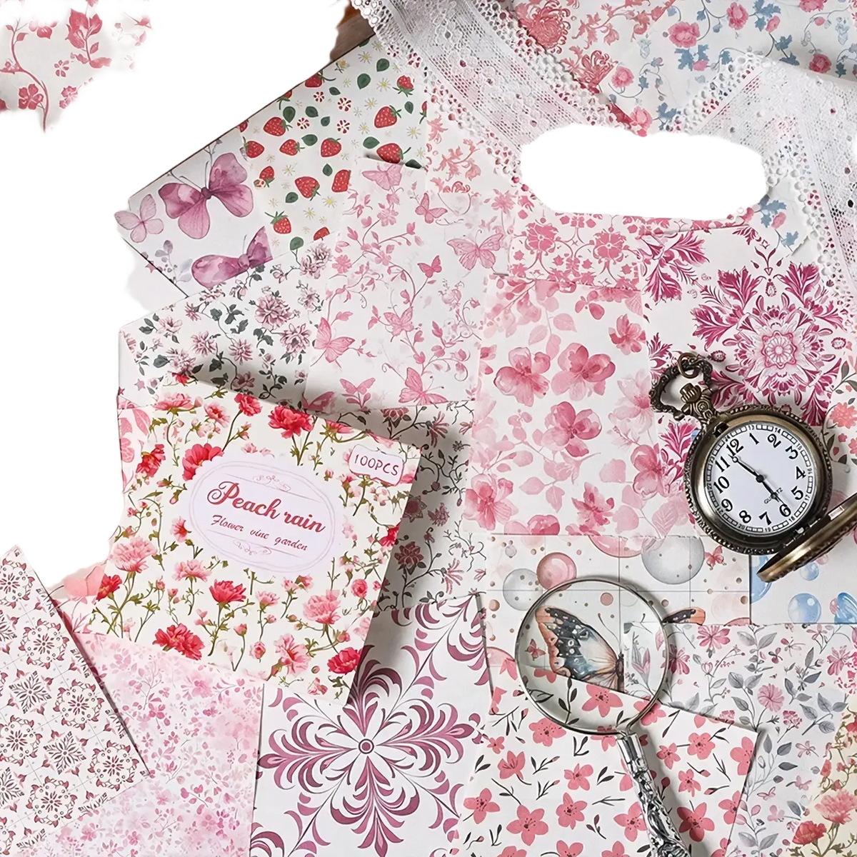 A delicate pink floral vintage scrapbooking paper pack labeled peach rain with a pocket watch and magnifying glass nearby