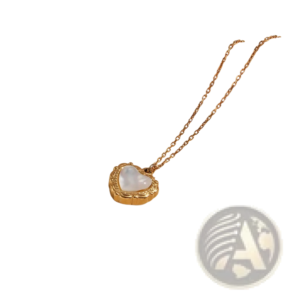 Gold heart-shaped locket with white mother-of-pearl interior and ornate detailing on a delicate gold chain vintage pendant