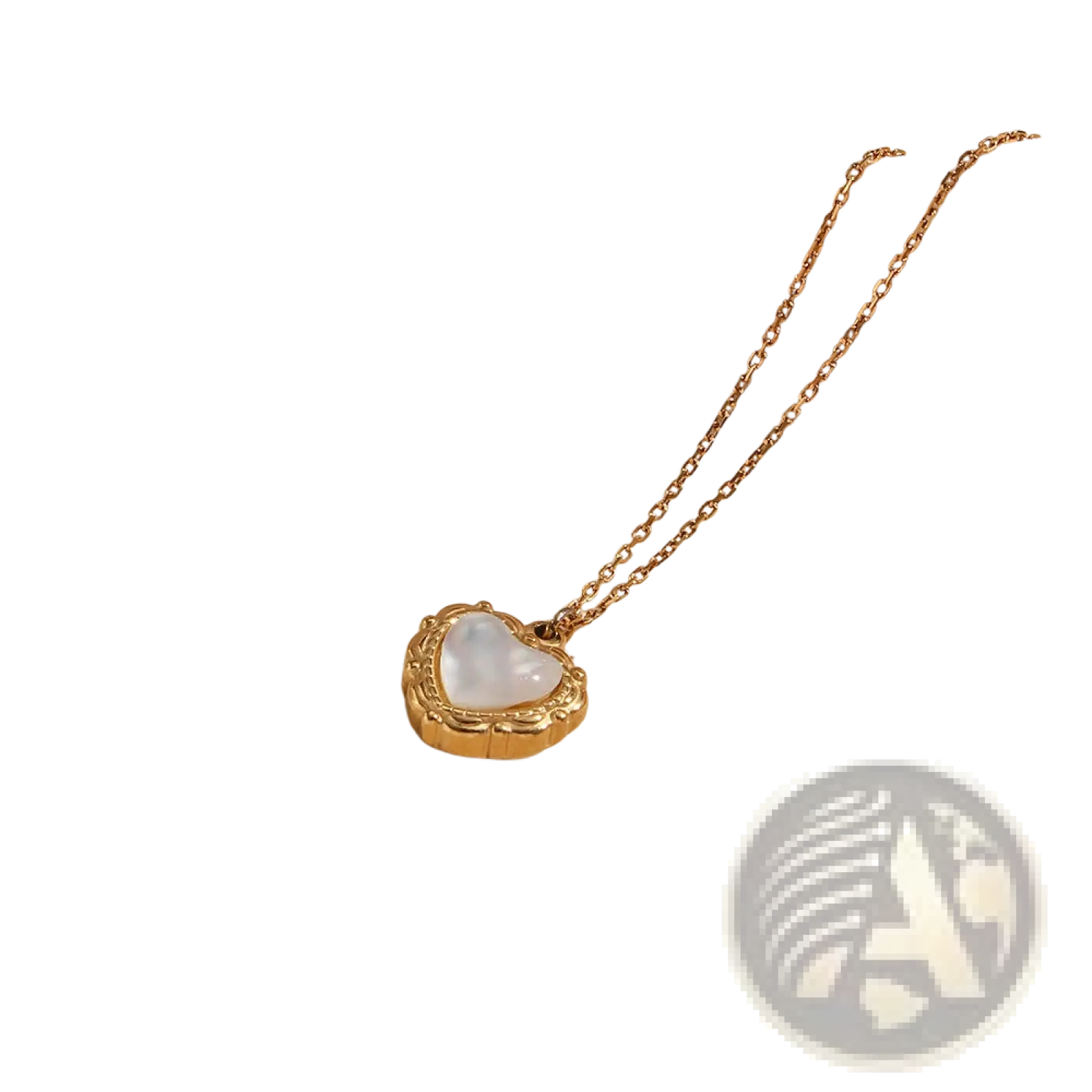 Gold heart-shaped locket with white mother-of-pearl interior and ornate detailing on a delicate gold chain vintage pendant