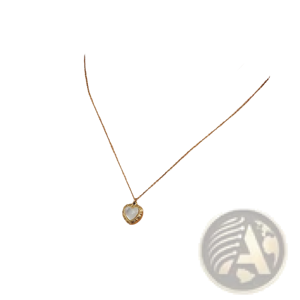 A delicate vintage shell heart pendant necklace in 18k gold plating with a textured border and pearlescent center