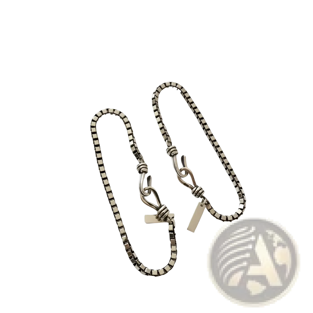 Silver-toned vintage box chain cross bracelet with twisted knot clasp and engraved rectangular tag detail