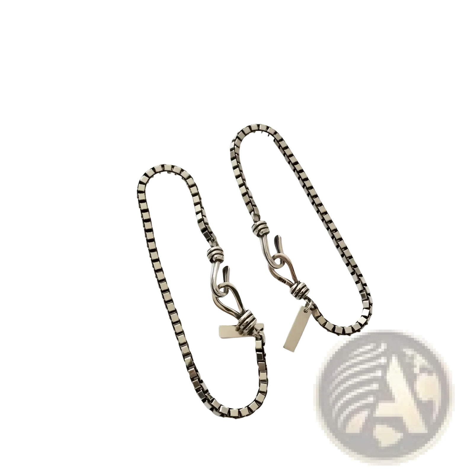 Silver-toned vintage box chain cross bracelet with twisted knot clasp and engraved rectangular tag detail