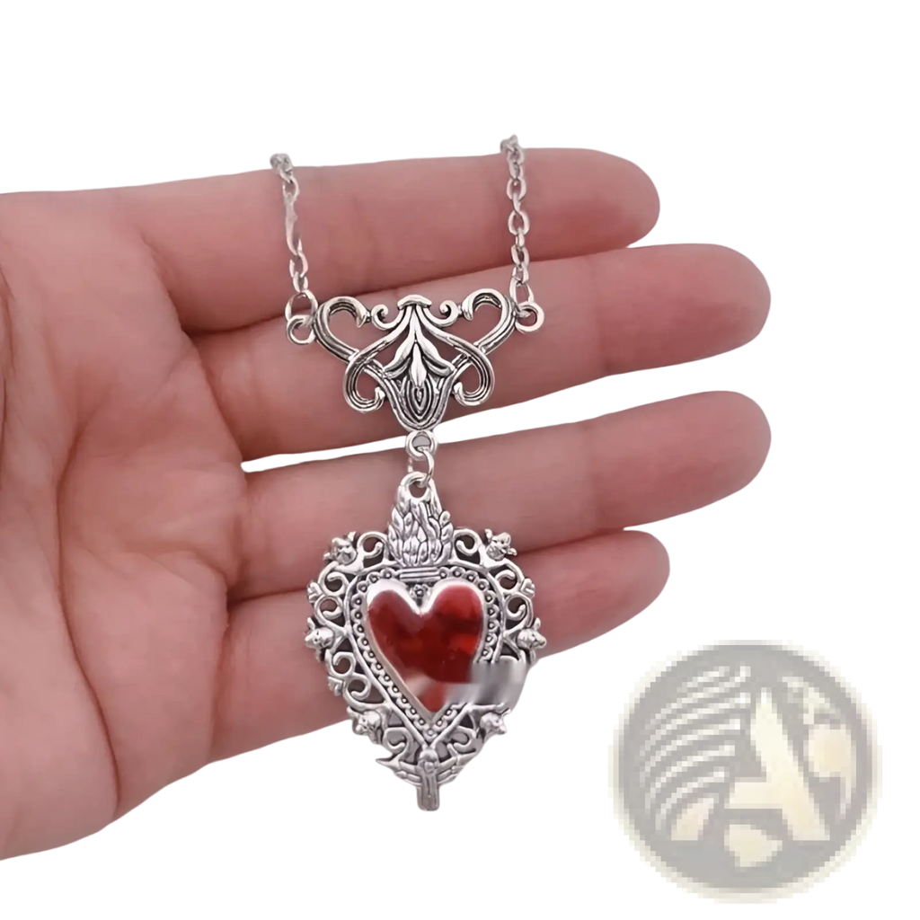 Vintage silver filigree heart pendant necklace with a vibrant red glass center for elegant wear