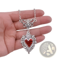 Vintage silver filigree heart pendant necklace with vibrant red enamel center and ornate vintage-inspired detailing