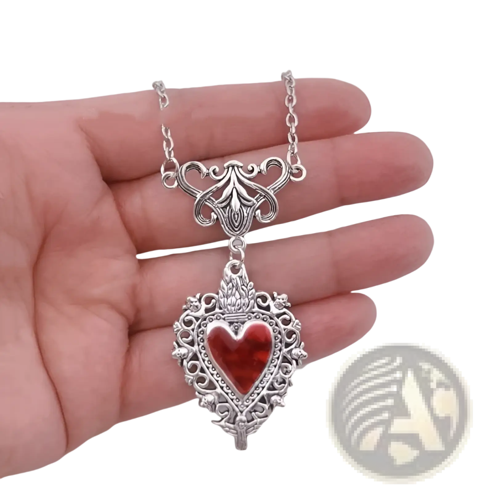 Vintage silver filigree heart pendant necklace with vibrant red enamel center and ornate vintage-inspired detailing