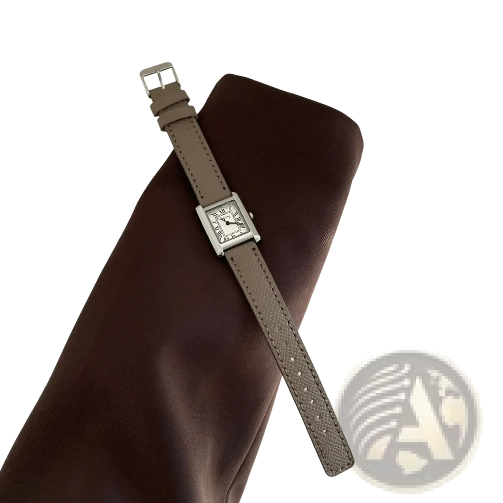 A vintage square quartz watch for women with a silver-toned minimalist face and taupe leather strap