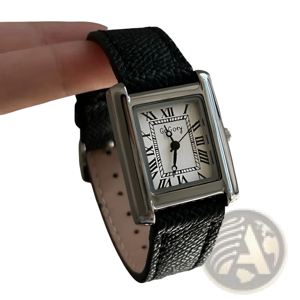 A sleek silver vintage square quartz watch for women with a white face, roman numerals, and black leather strap