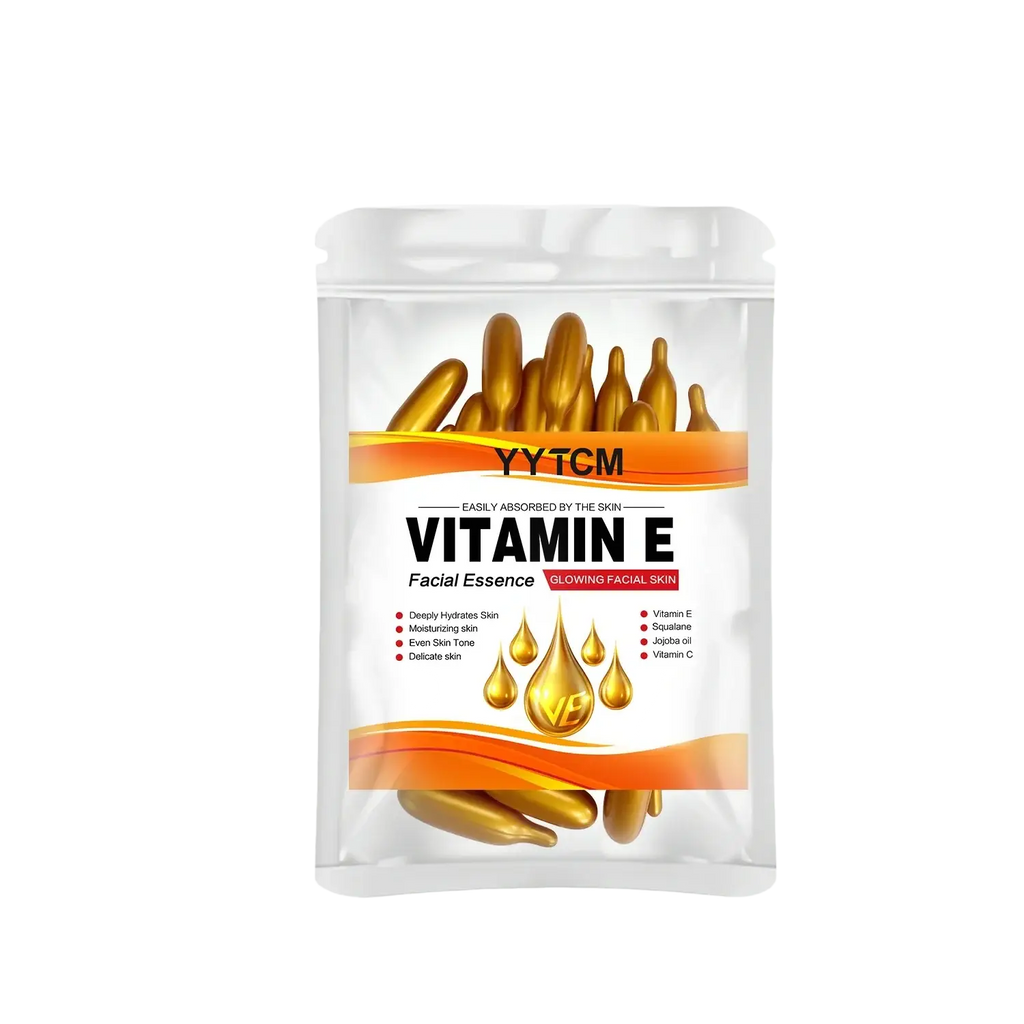 A clear plastic pouch of yytcm vitamin e moisturizing face serum capsules with golden essence and orange accents