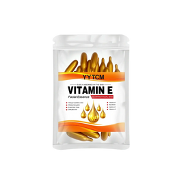 A clear plastic pouch of yytcm vitamin e moisturizing face serum capsules with golden essence and orange accents