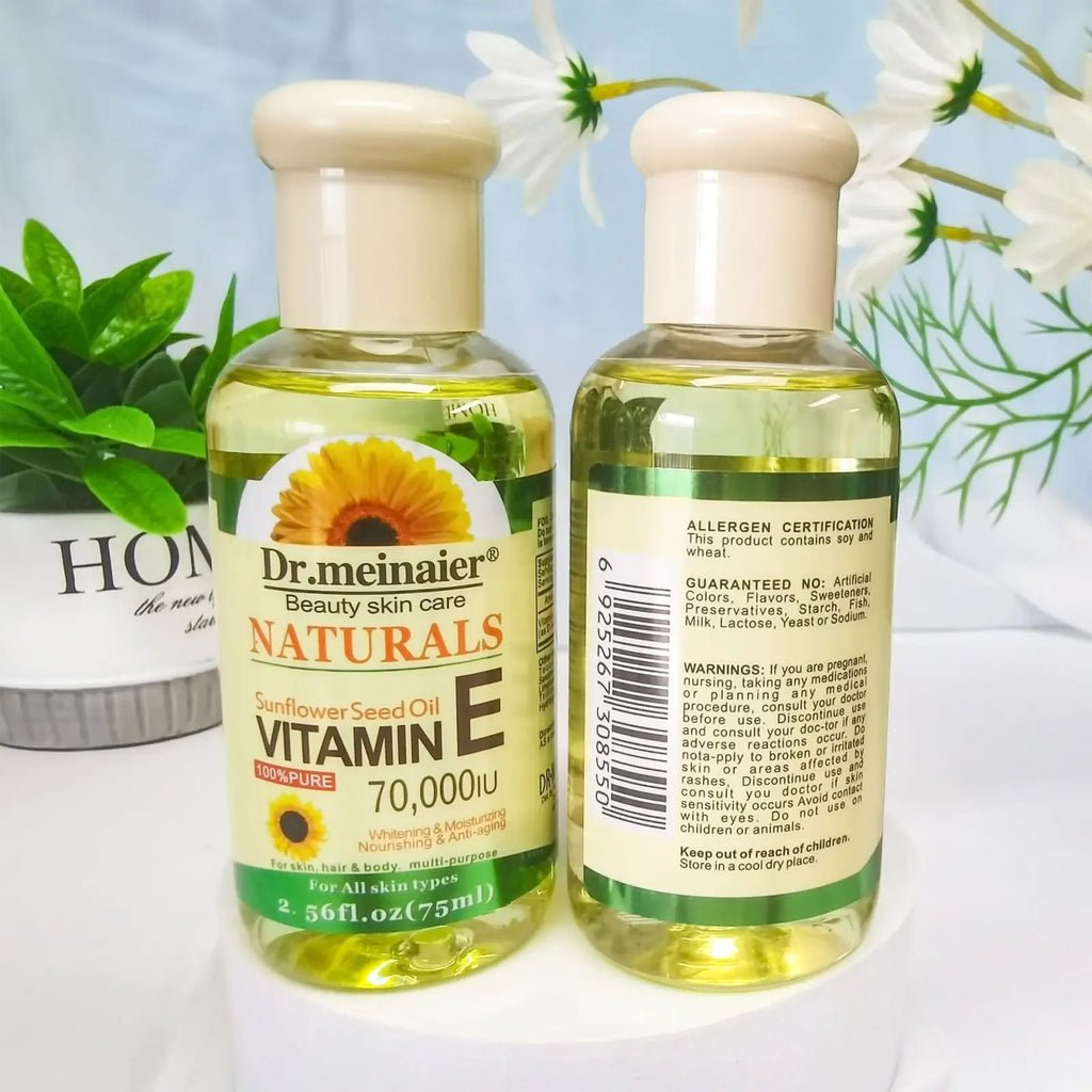Two clear glass bottles of dr vitamin e synthesis oil for face body and hair 75ml with amber liquid inside