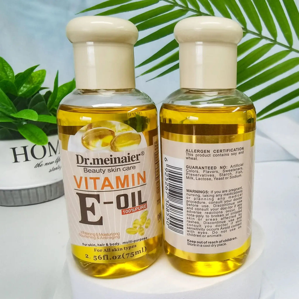 Two clear glass bottles of dr vitamin e synthesis oil for face body and hair 75ml showing the front labels