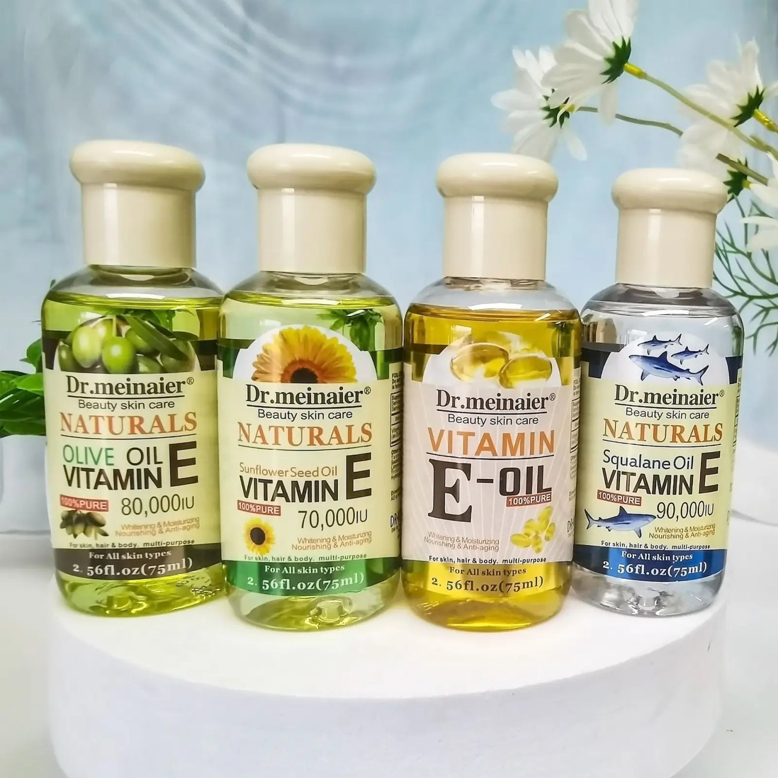 Four transparent bottles of dr vitamin e synthesis oil for face body and hair 75ml shown from the front side