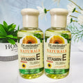 Two clear glass bottles of dr vitamin e synthesis oil for face body and hair 75ml shown from the front side