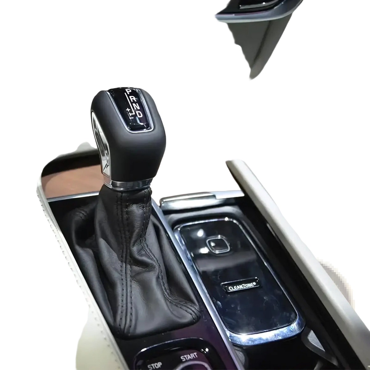 Volvo cleanzone wireless car charger and air purifier shown with black leather-wrapped gear shift knob with chrome accents and engraved prnd markings