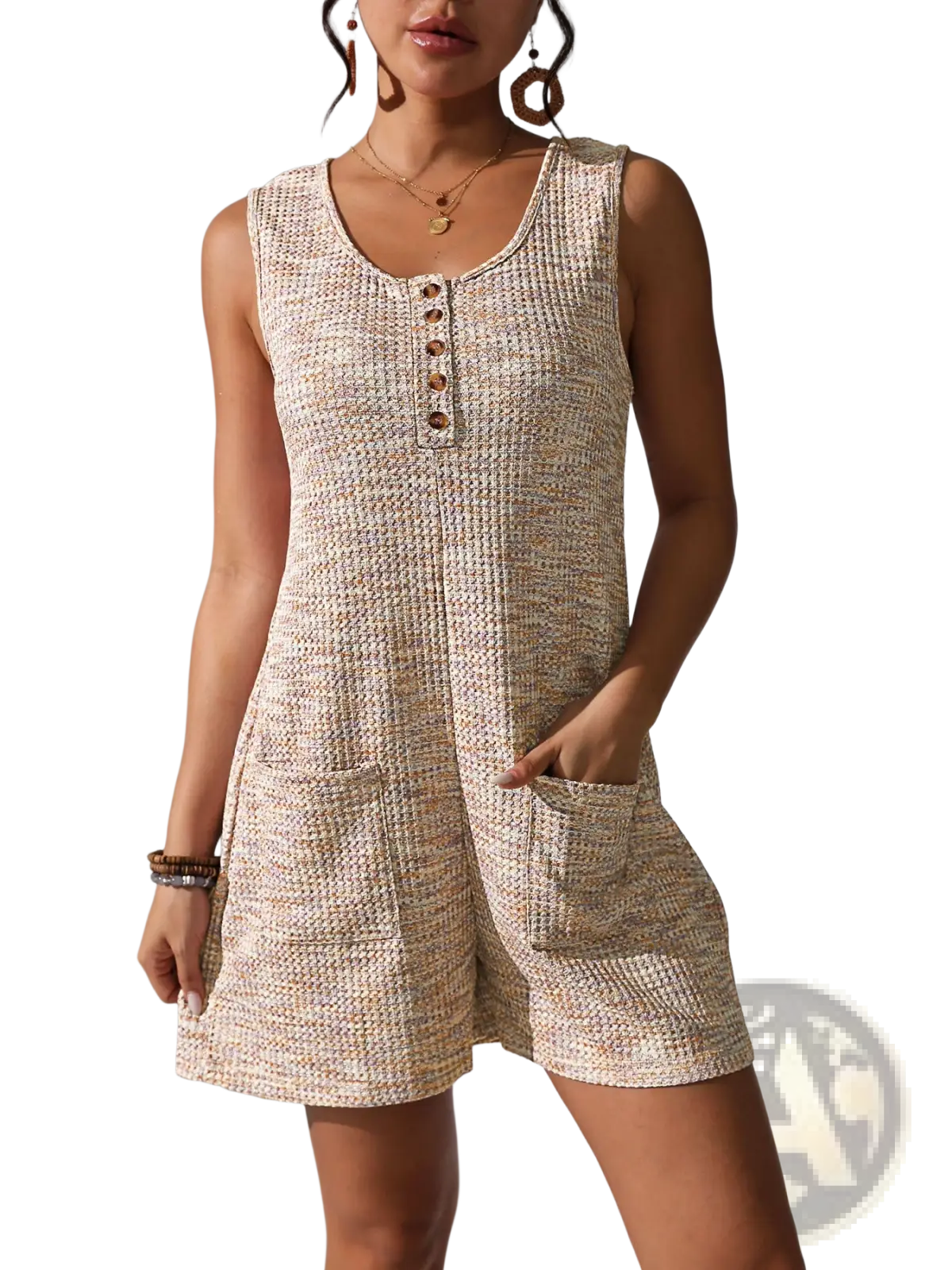 Beige waffle knit sleeveless jumpsuit with button front detail and side pockets featuring textured fabric