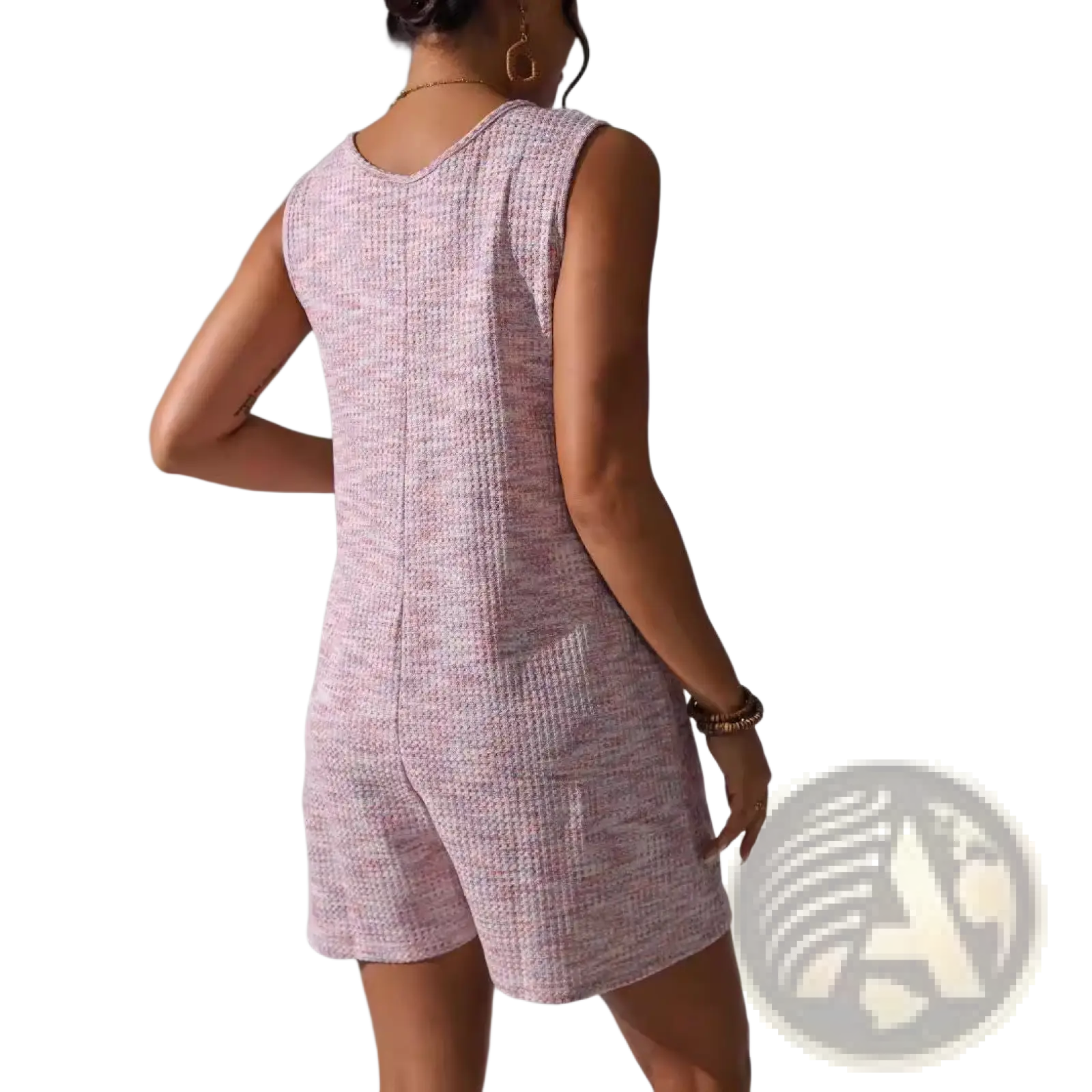 A soft pink waffle knit sleeveless romper with button front, pocket detail, rounded neckline, and textured pattern