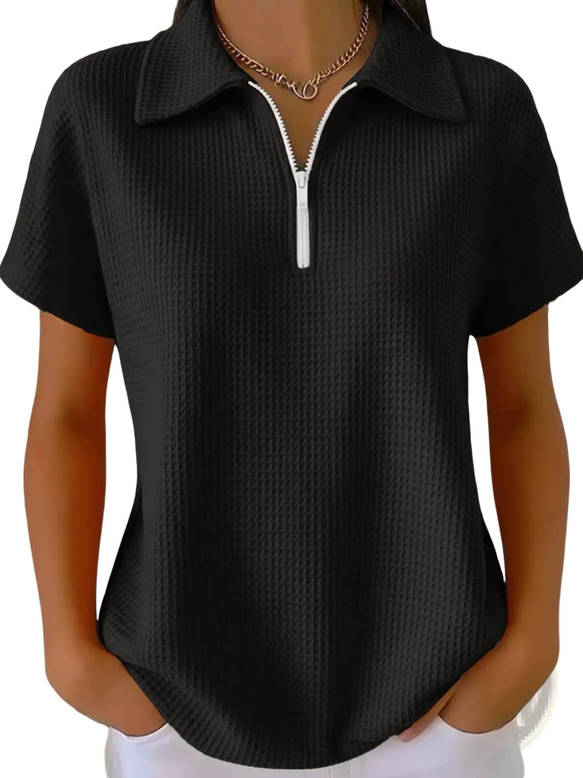Black waffle knit half zip short sleeve polo shirt with ribbed texture and white zipper pull and collar detail