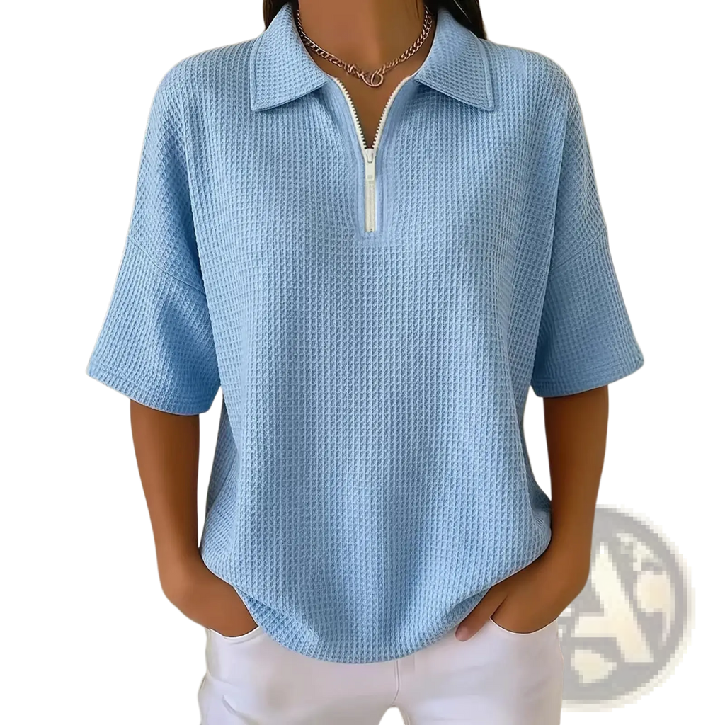 Light blue waffle knit half zip short sleeve polo shirt with white zipper at collar made of textured fabric