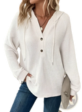 Cream-colored waffle knit v neck button front hoodie with three dark buttons and hood drawstrings
