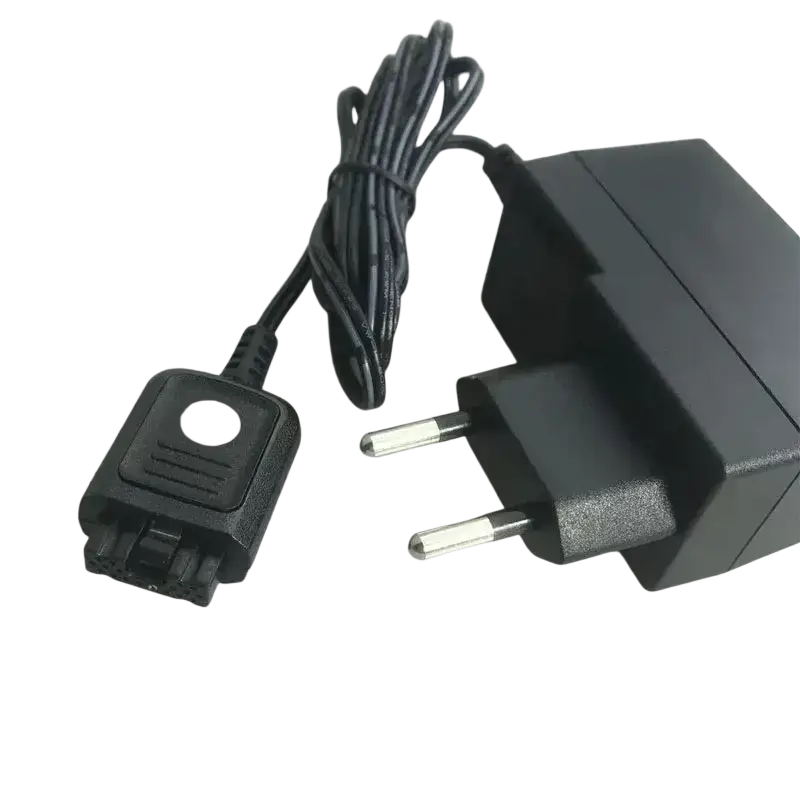 Black plastic wall charger for motorola tetra radio with coiled cable and european-style plug