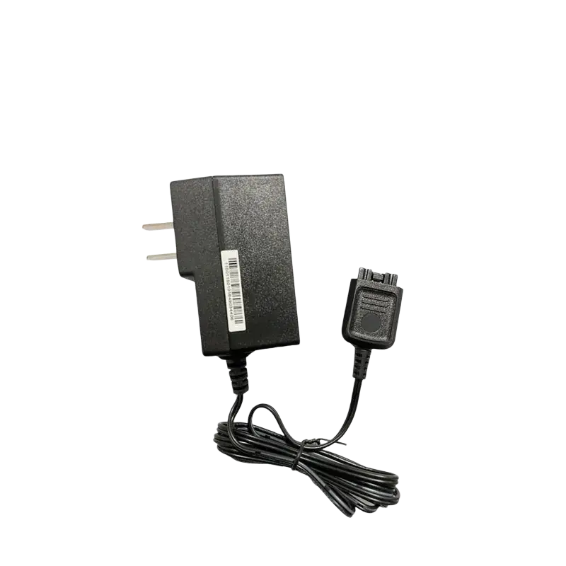 Black plastic wall charger for Motorola Tetra radio with two-prong plug and coiled cord ending in rectangular connector