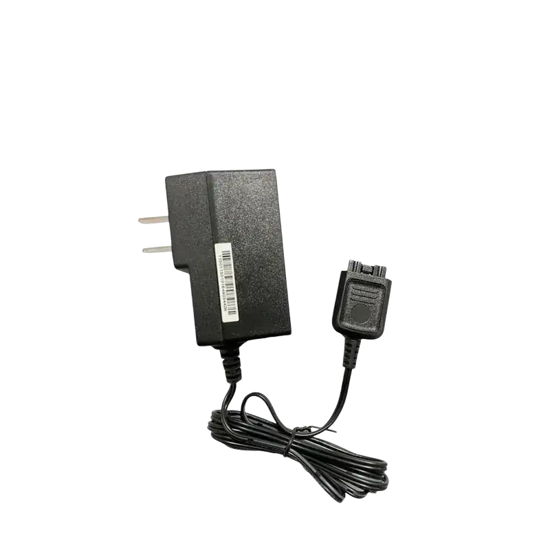 Black plastic wall charger for Motorola Tetra radio with coiled cord and proprietary connector for secure charging