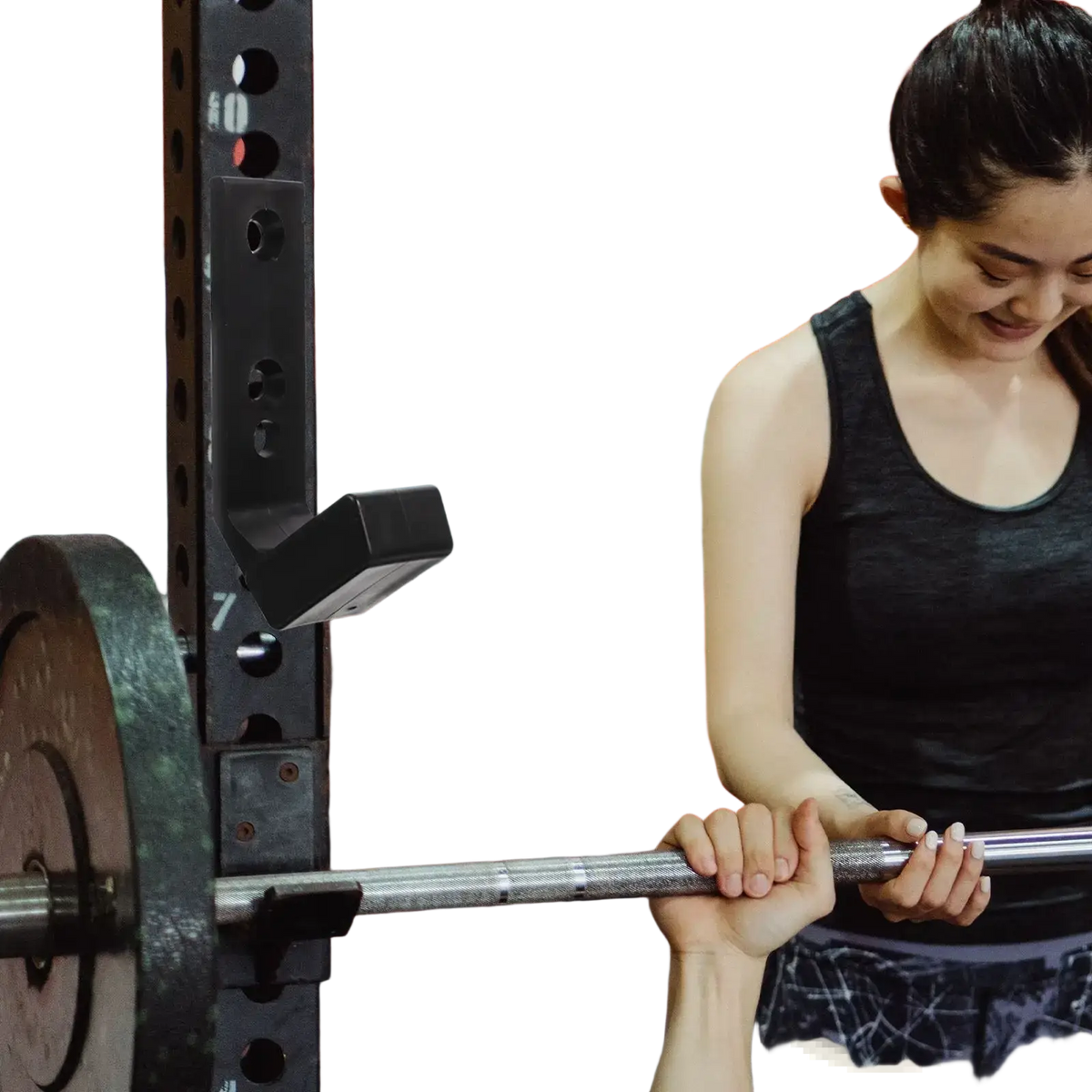 Black wall mounted barbell storage rack holding a silver metal shaft barbell with dark worn weight plates