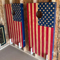 Birch plywood wall mounted cornhole board storage brackets holding american flag themed red white and blue cornhole boards