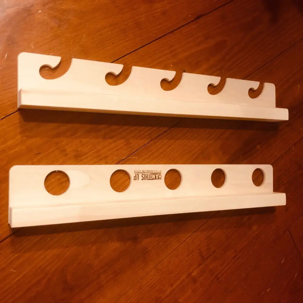 Two light-colored birch wooden wall-mounted hooks with curved slots and circular holes for wisa birch wave fishing rod rack