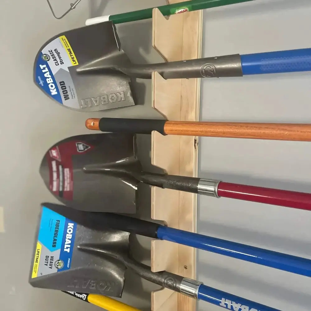 Lancaster wooden wall mounted garden tool rack holding a blue-handled kobalt shovel with black grip and metallic blade