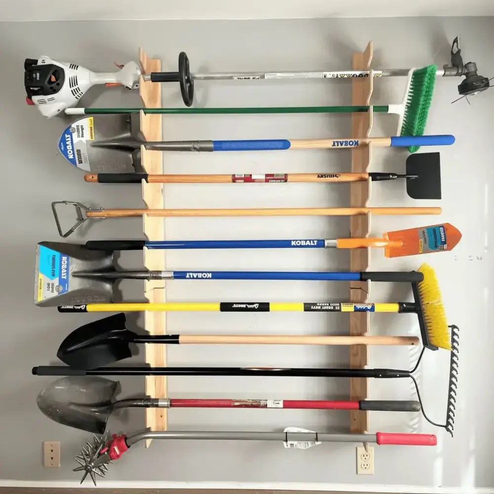Lancaster wooden wall mounted garden tool and shovel rack holding black and orange handled shovels blue rakes and green brushes